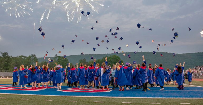 A photograph of the North Schuylkill graduating class of 2025 throwing their caps in the air