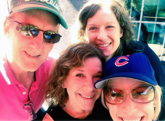 Dr. John Rosella smiles in a casual outdoor group photo with family members on a sunny day.